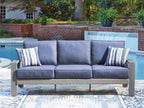 Blue outdoor loveseat sofa with two striped pillows and thick cushioned backrest