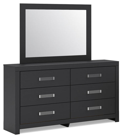 Black dresser with attached mirror and four drawers with silver bar pulls