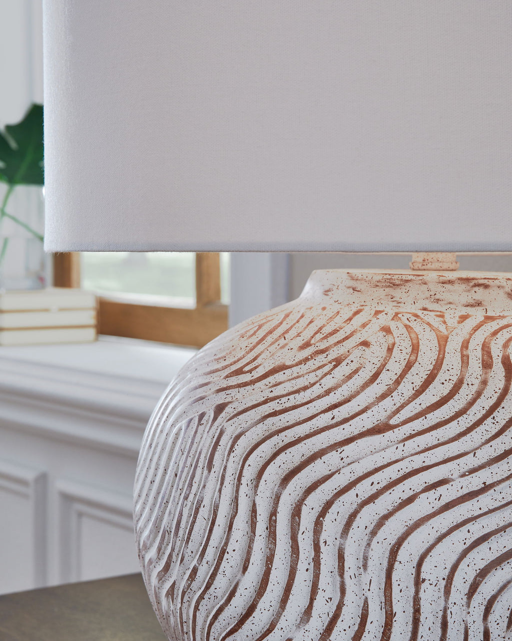 Table lamp base and white drum shade with distressed textured surface and terracotta lines
