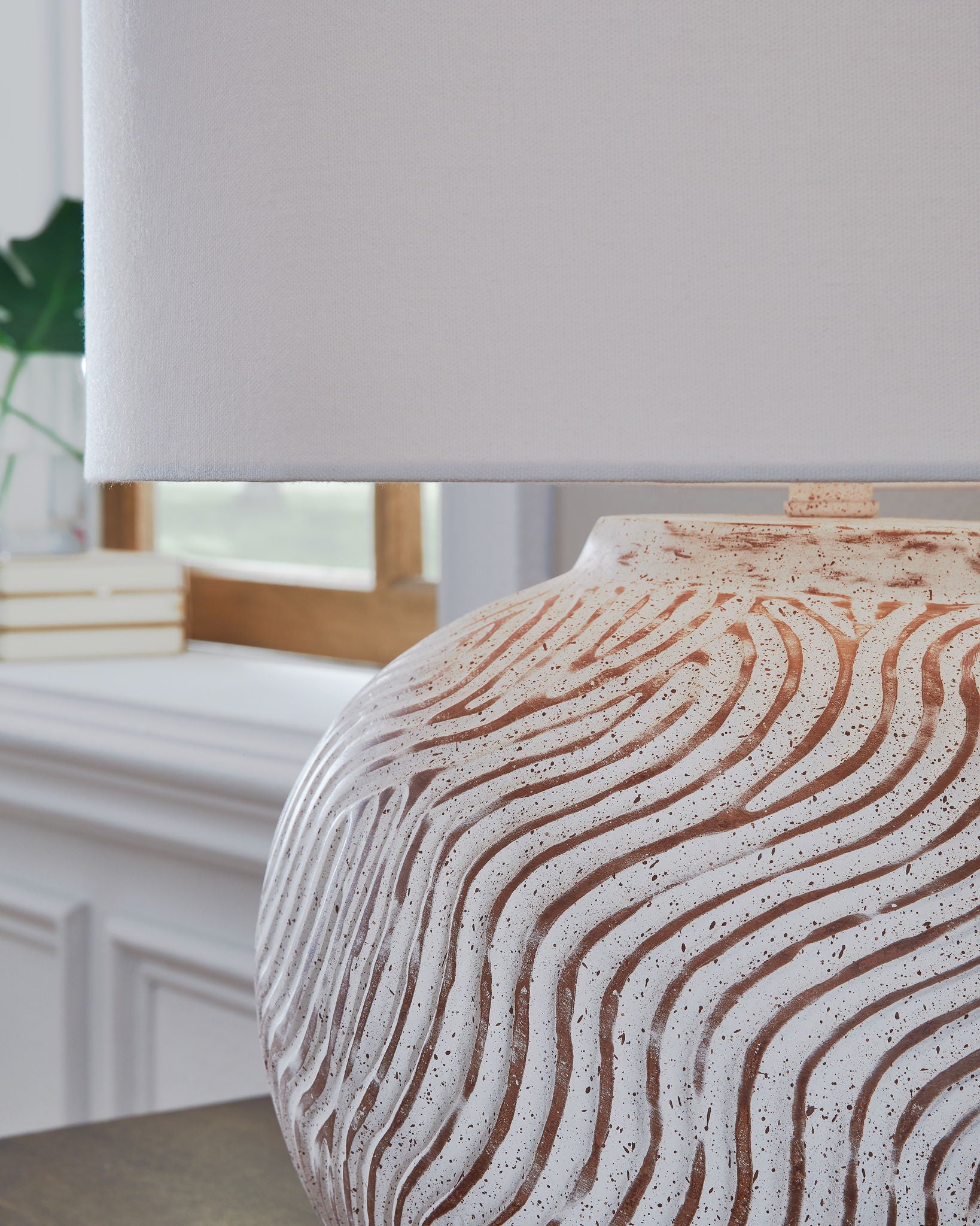 Table lamp base and white drum shade with distressed textured surface and terracotta lines