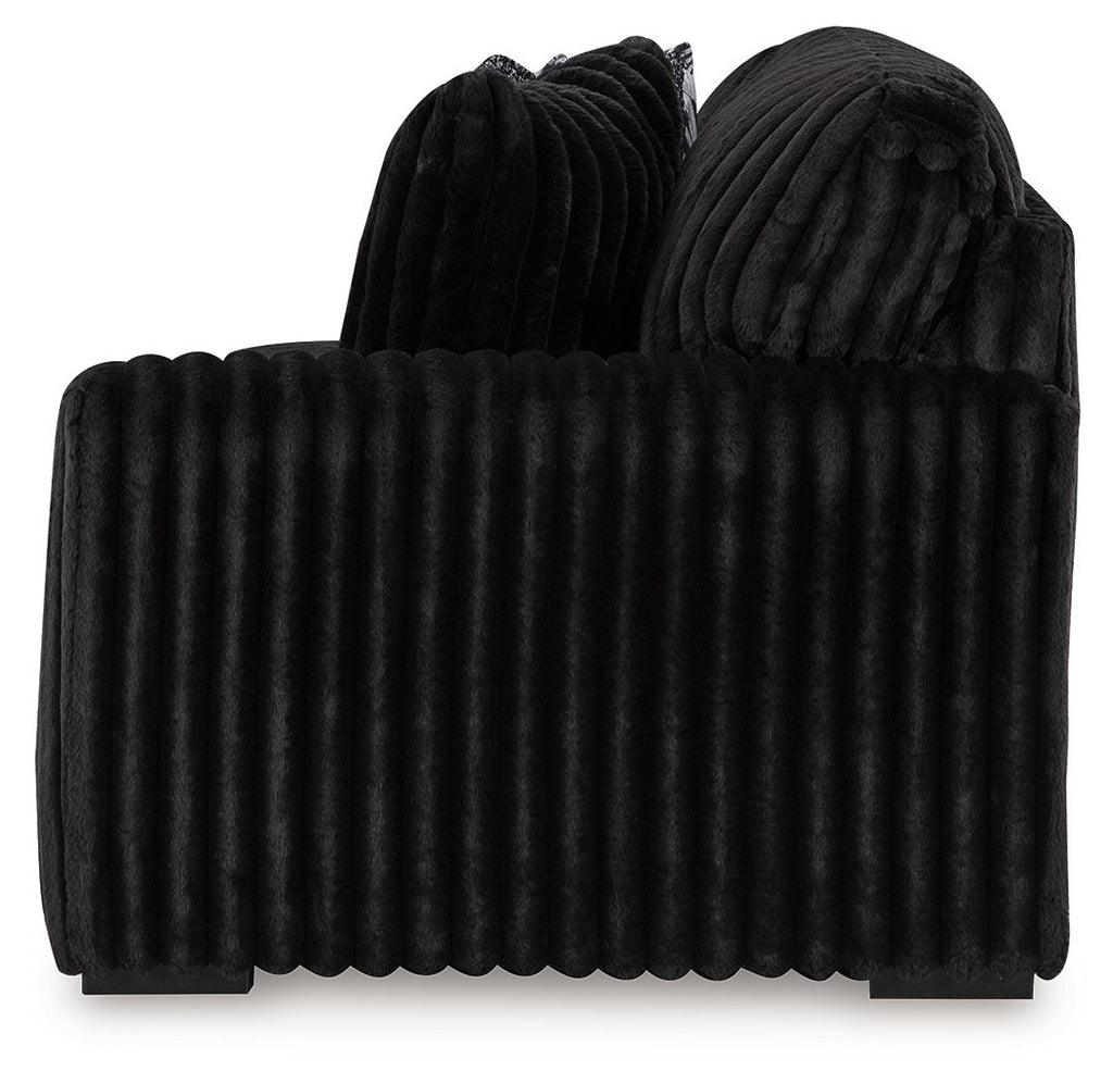 Onyx dark velvet sofa with vertical channel back and rounded thick arms