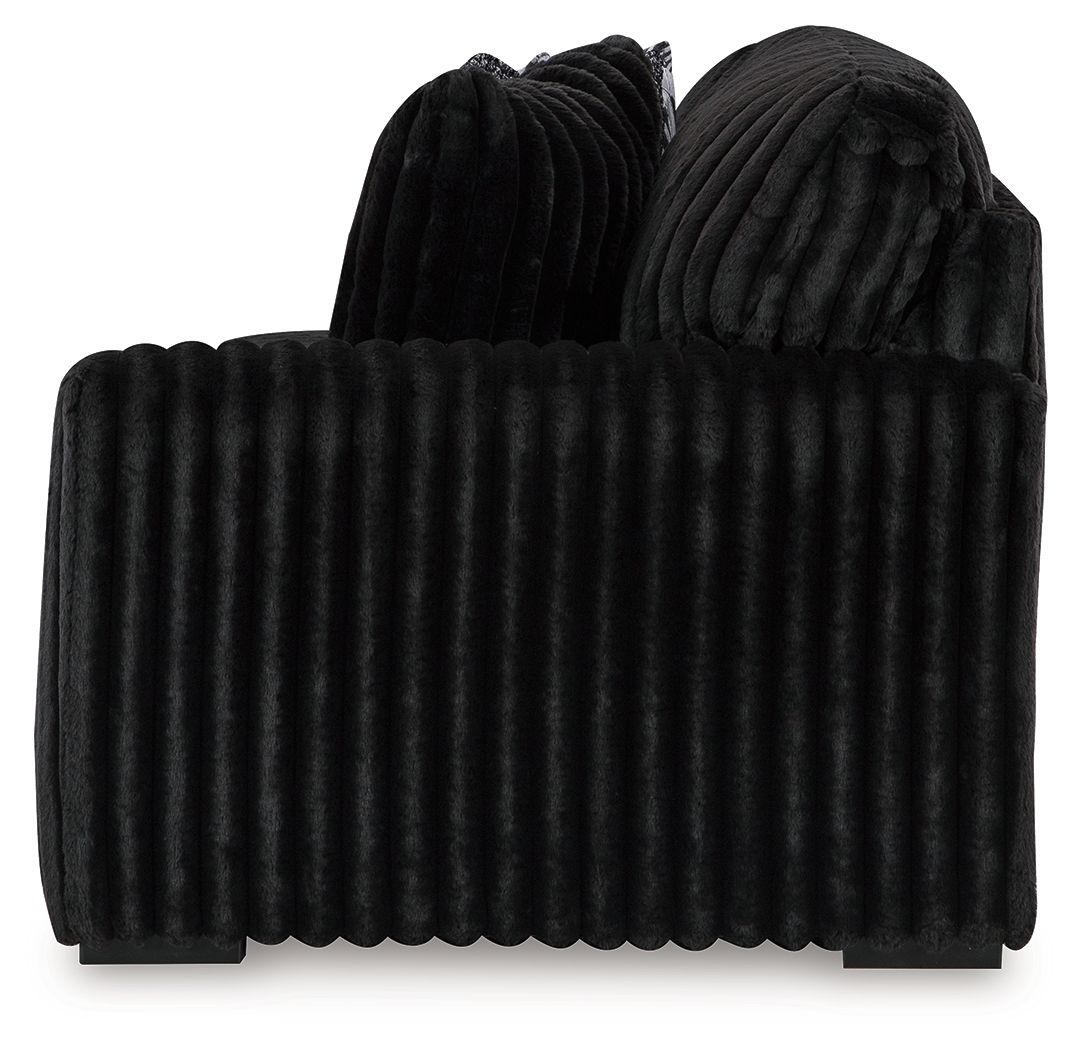 Onyx dark velvet sofa with vertical channel back and rounded thick arms