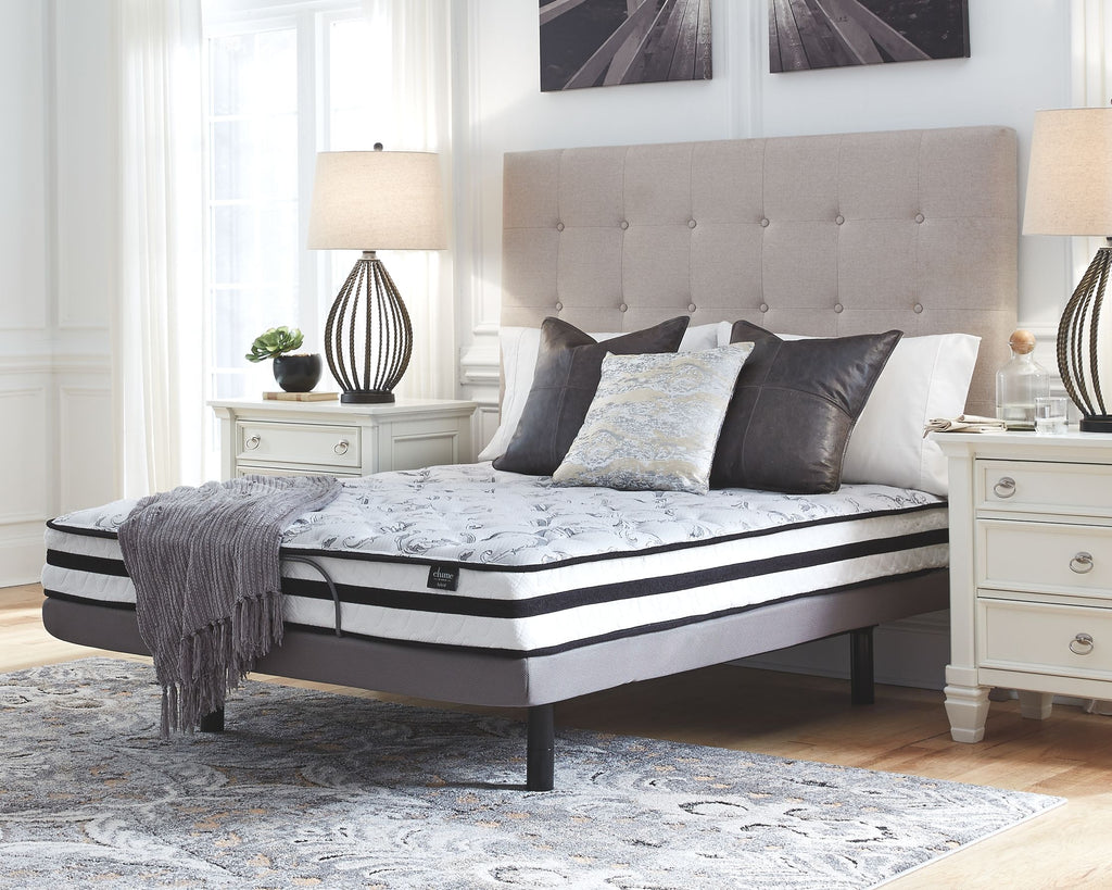 Firm innerspring mattress with quilted top, black edge band, and dark base