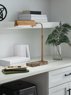 Bronze metal floor lamp with rectangular shade on curved stem and stone base
