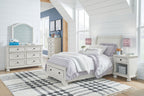 White youth sleigh bedroom set with bed, dresser, and matching nightstand