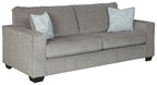 Alloy sleeper sofa in a side angle with two square patterned throw pillows