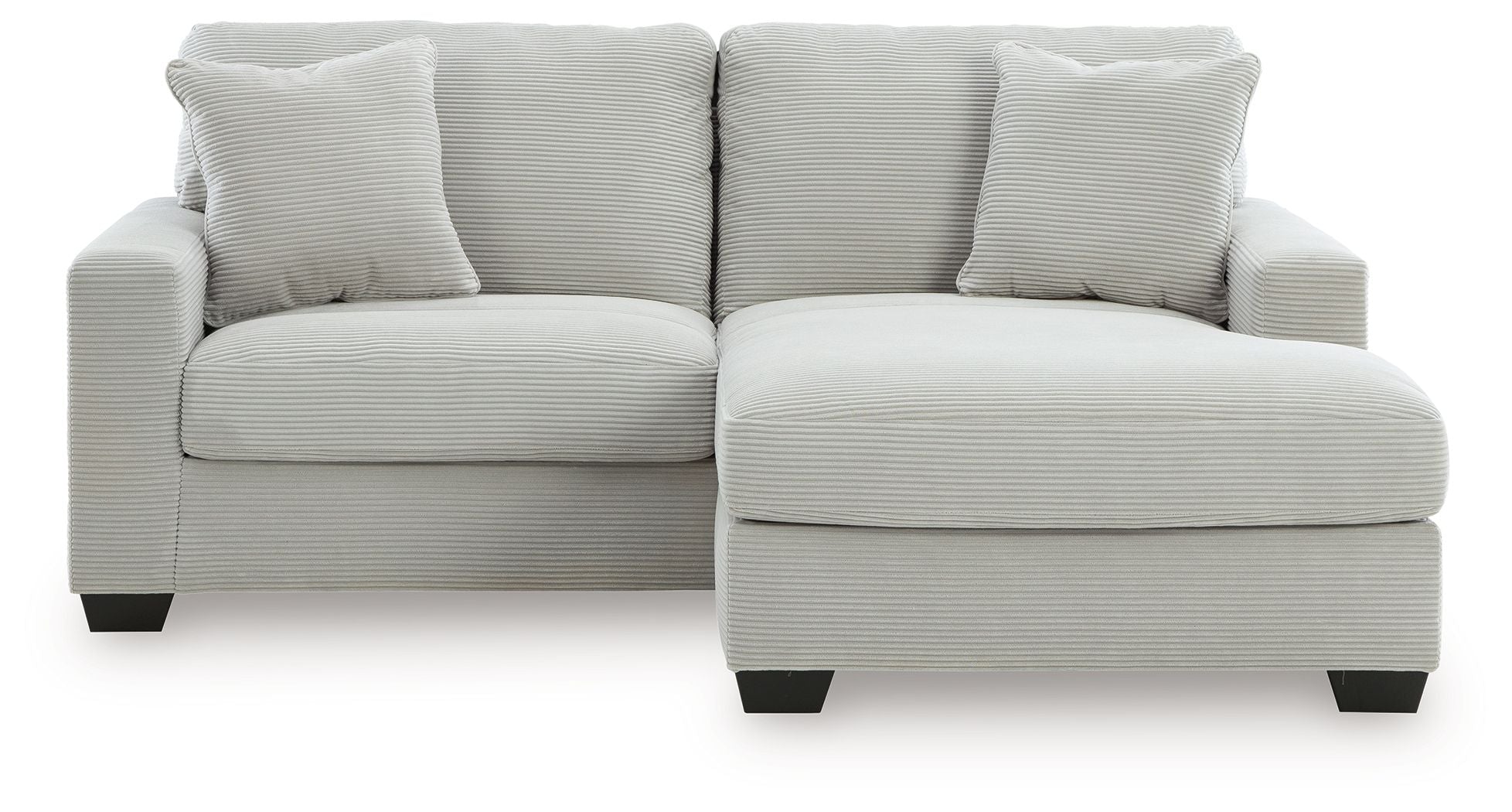 White sofa chaise with three front seat cushions and a chaise ottoman extension
