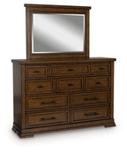 Medium brown dresser with matching mirror, six drawers and carved trim