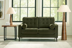 Olive green tufted loveseat with rounded arms, two bolster pillows, and tapered legs.