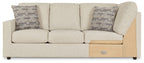 Pearl silver wedge sofa with two patterned throw pillows and a light wood side panel