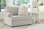 Light gray chair and a half with back cushion and striped throw pillow
