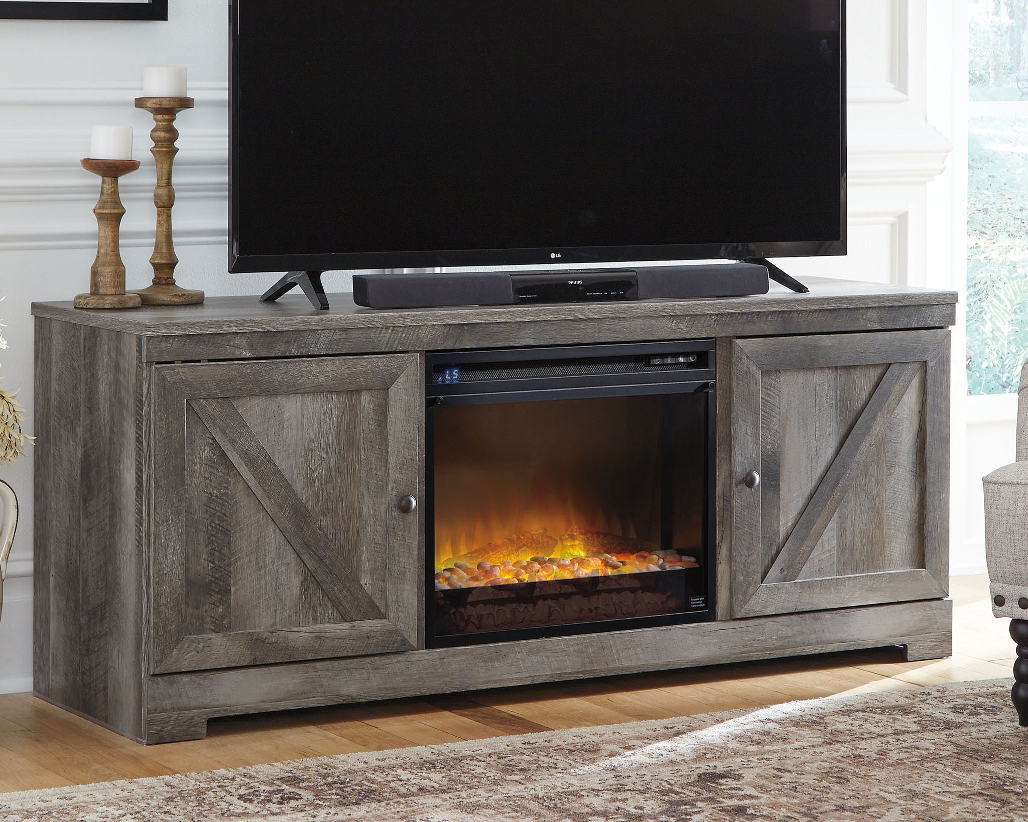 Gray TV stand with center glass fireplace insert and two side cabinet doors