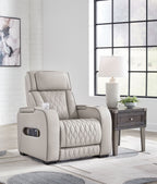 Gray power recliner in living room view, with adjustable headrest and quilted backrest