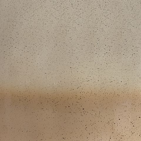 Speckled beige ceramic lamp base texture close-up