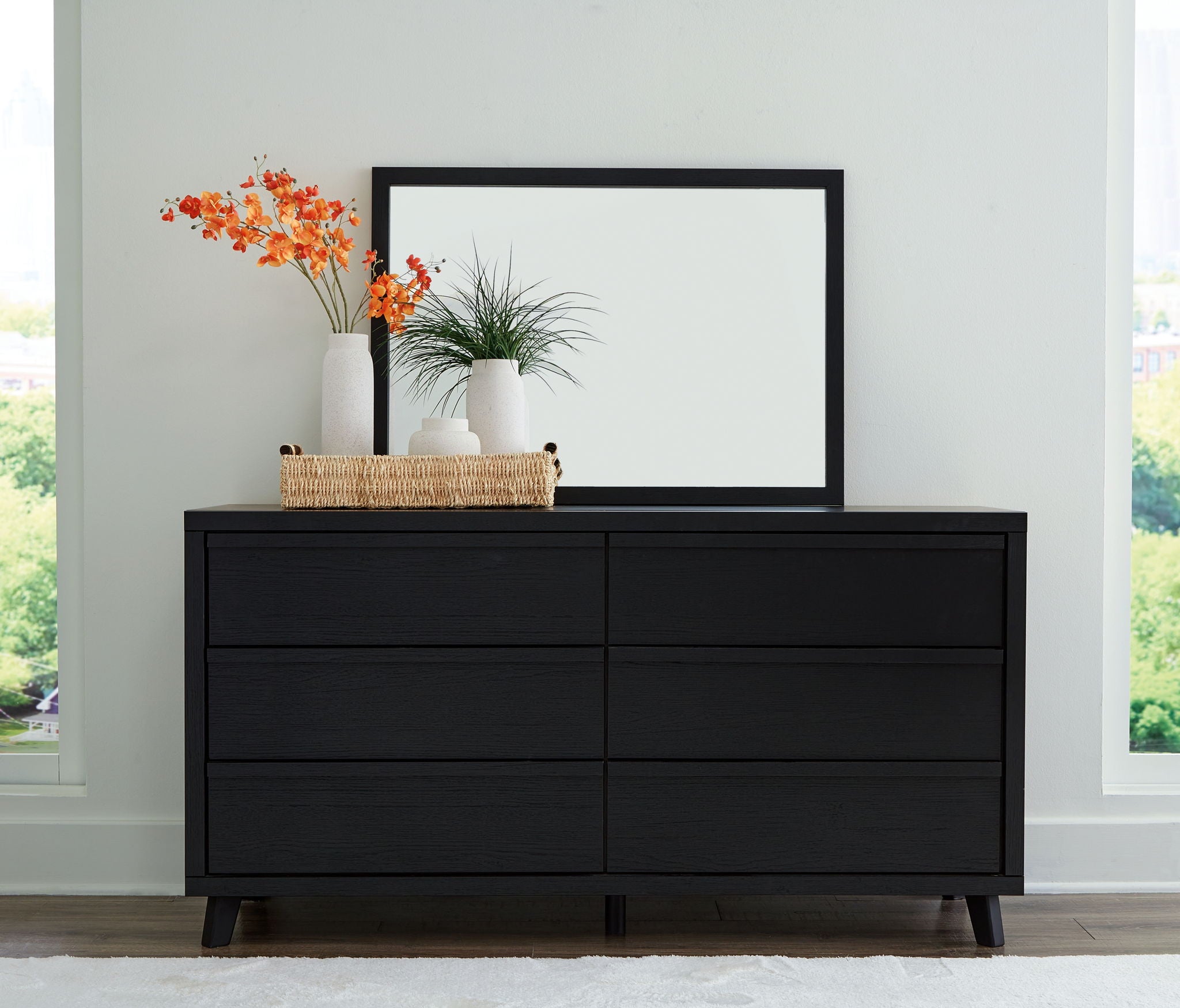 Black panel dresser with framed mirror, four drawers and two doors