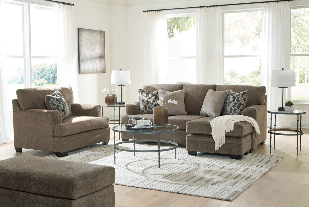 Taupe fabric living room sectional set with chaise, sofa, ottoman, and patterned pillows