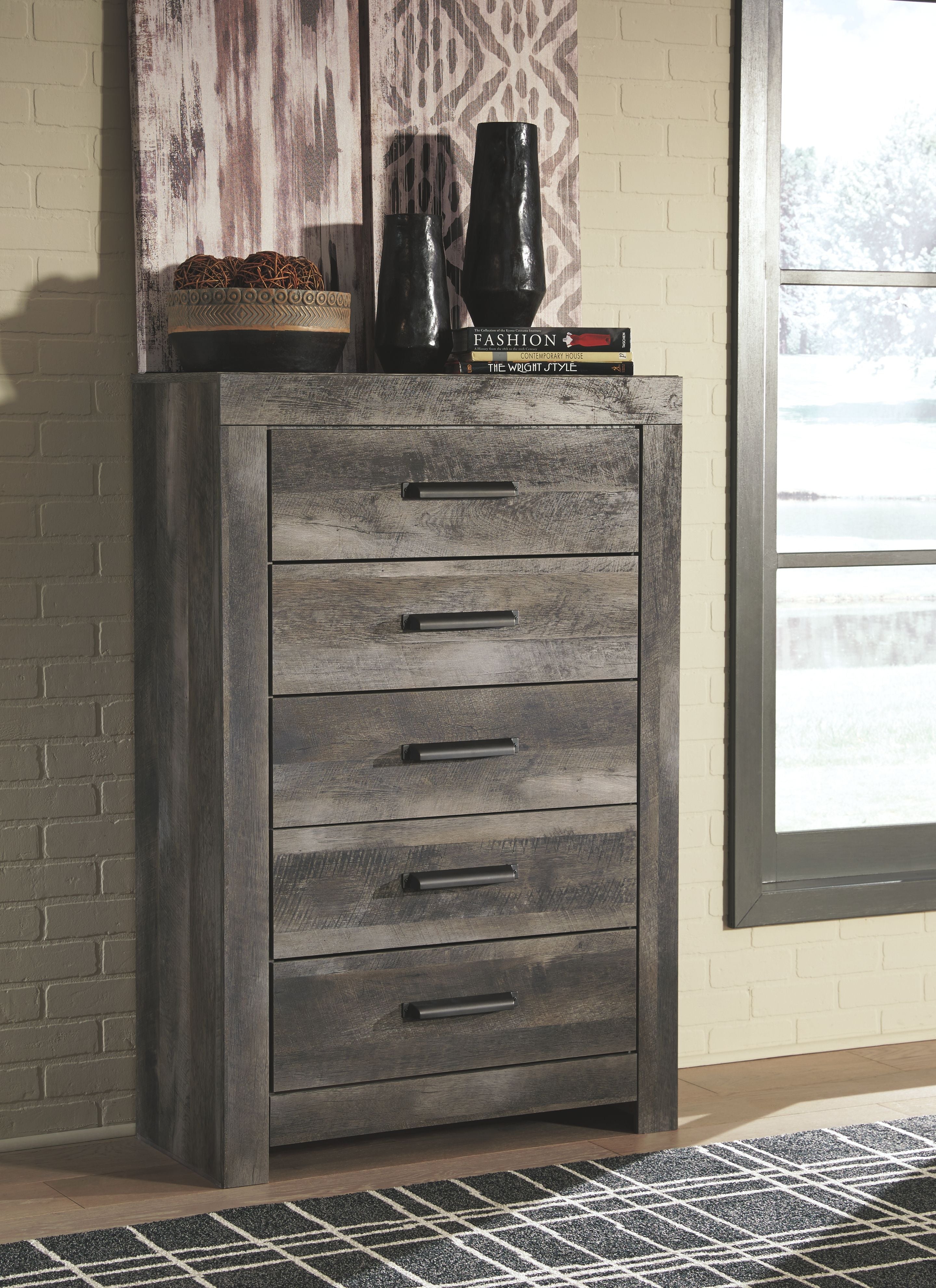 Gray five-drawer chest with dark metal bar pulls and distressed finish.