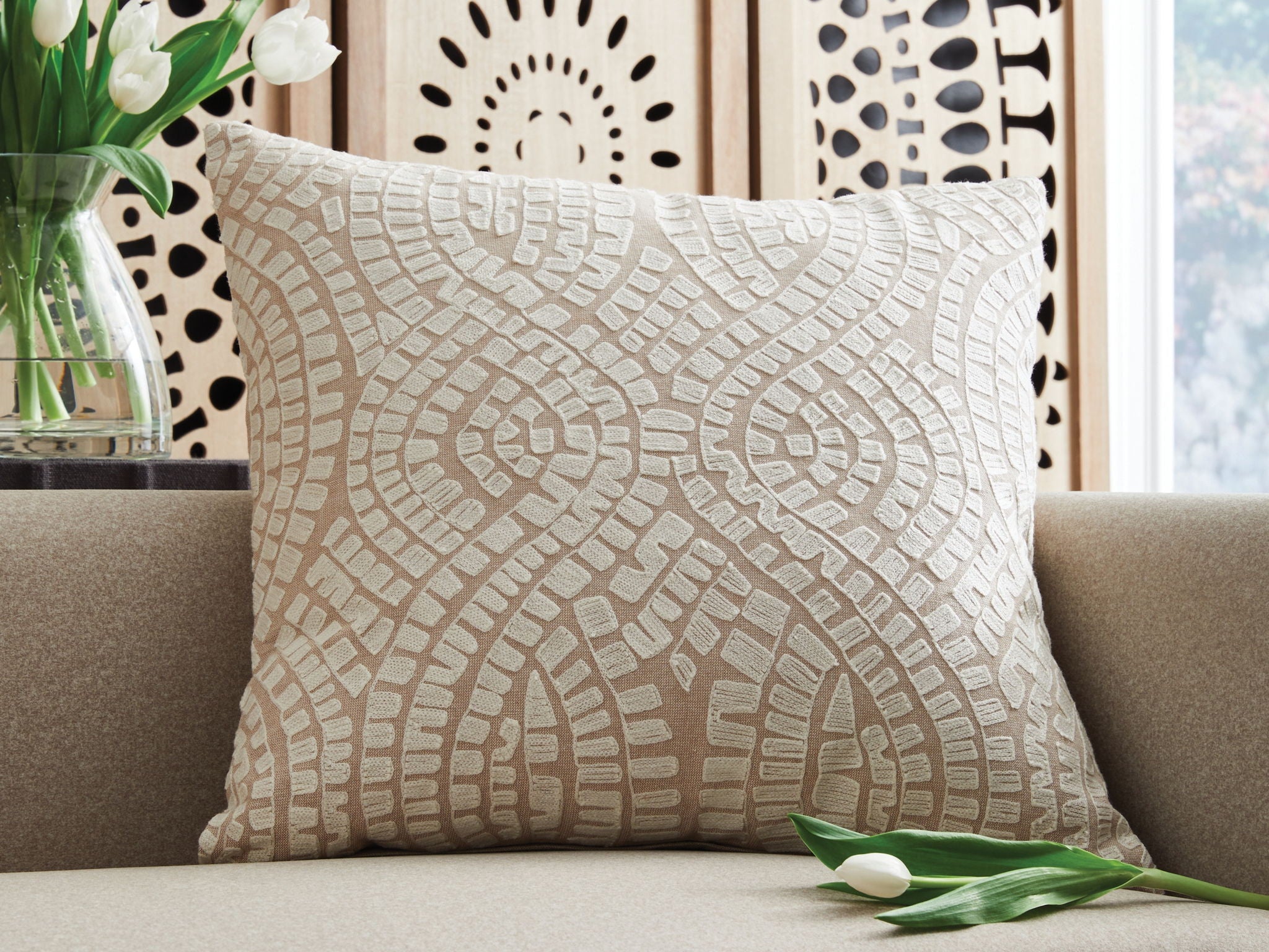 Beige and ivory geometric-pattern throw pillow on sofa, square cotton cover