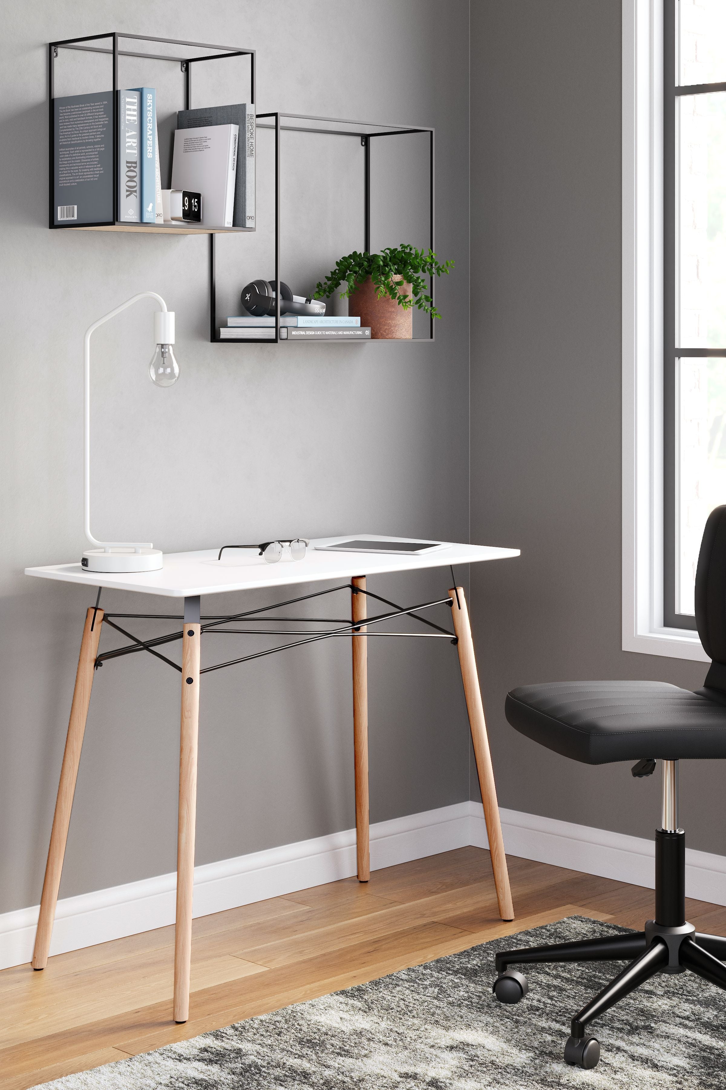 Jaspeni home office desk with white tabletop and light wood legs, black cross-braced frame