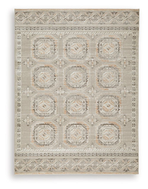 Light beige rug with repeating octagon medallions and ornate border details