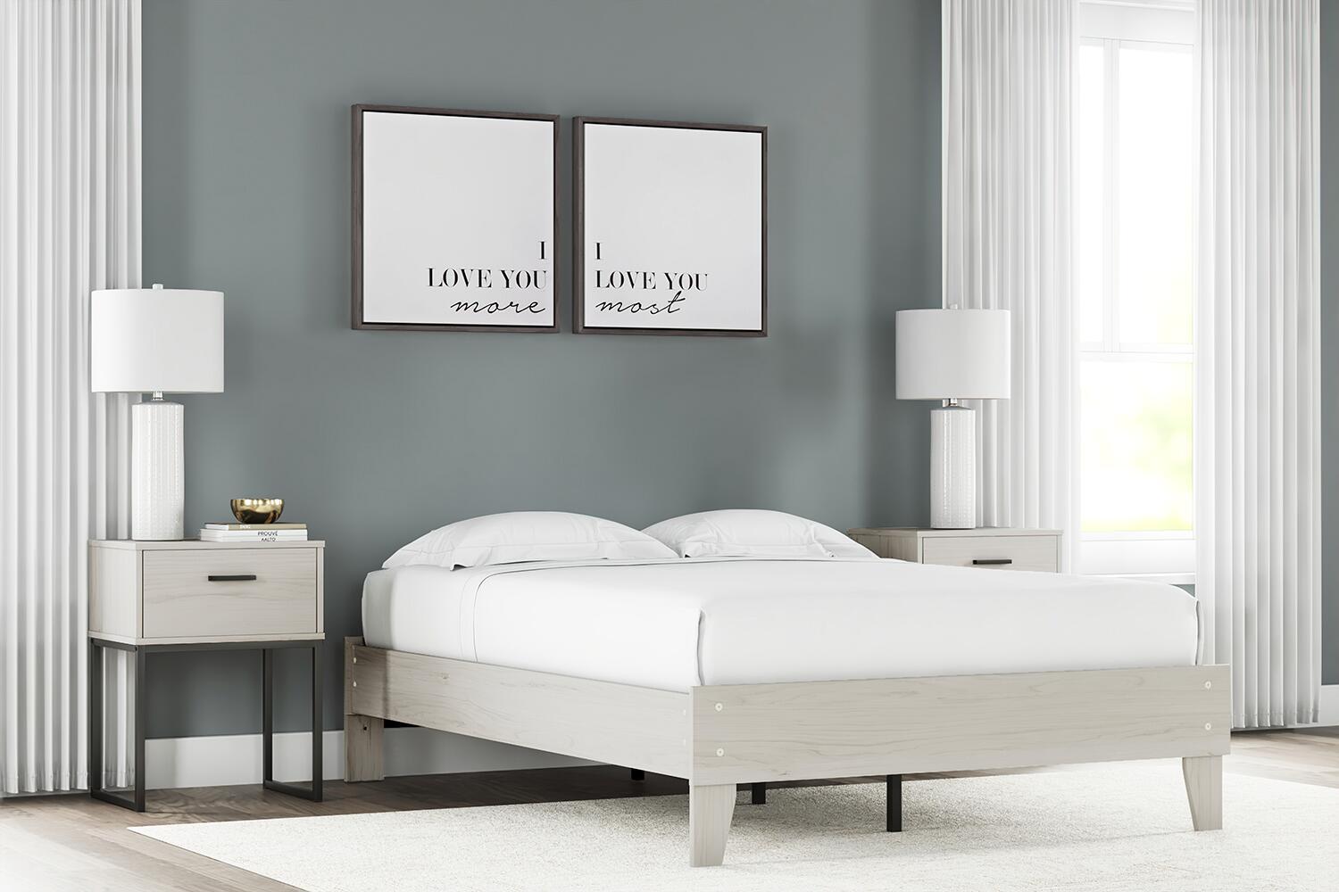 Platform bed with light wood frame and white mattress, in a bedroom setting