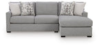 Dark gray sleeper sectional sofa with chaise ottoman and geometric throw pillows