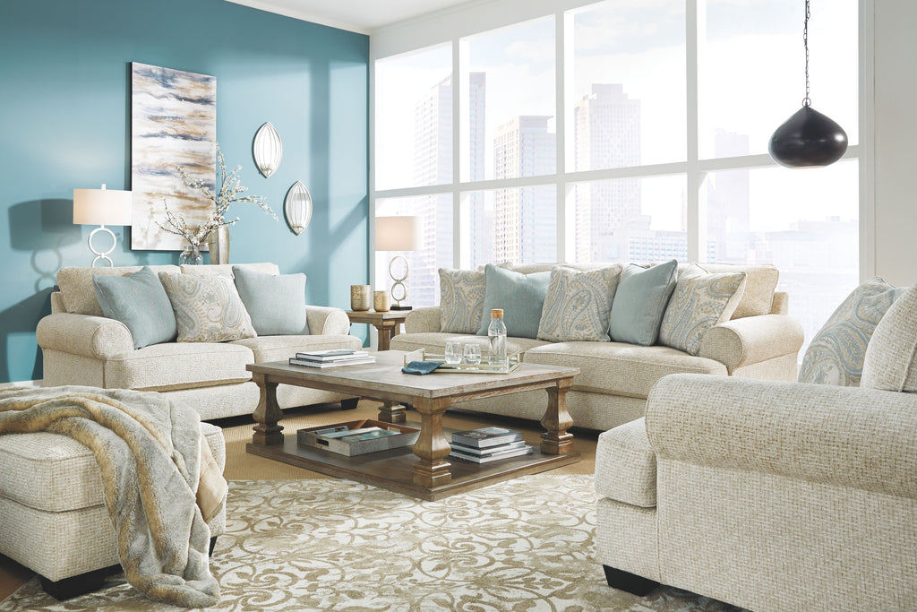 Upholstered sectional sofa with light beige fabric and blue patterned pillows