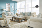 Upholstered sectional sofa with light beige fabric and blue patterned pillows