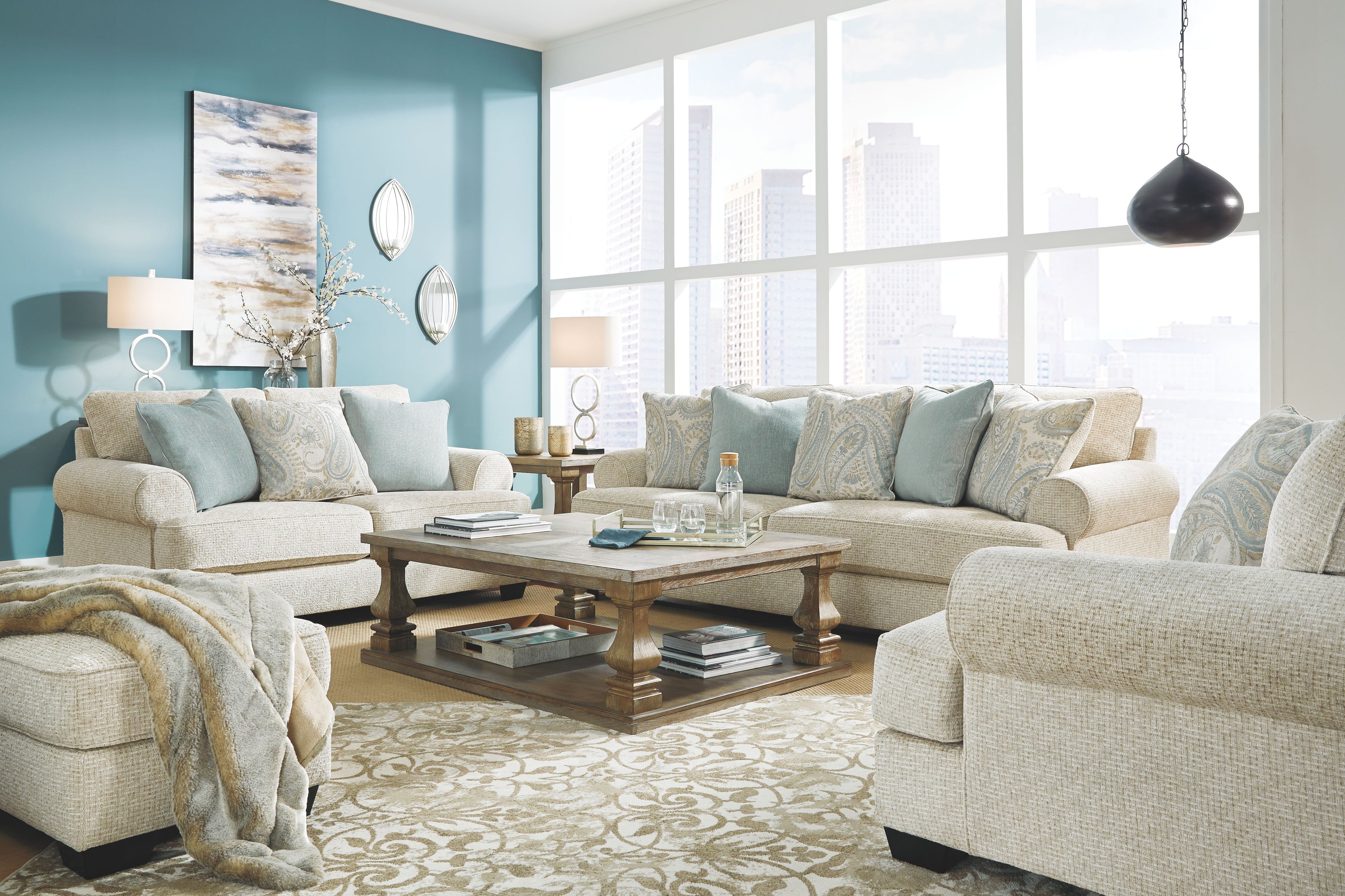 Upholstered sectional sofa with light beige fabric and blue patterned pillows