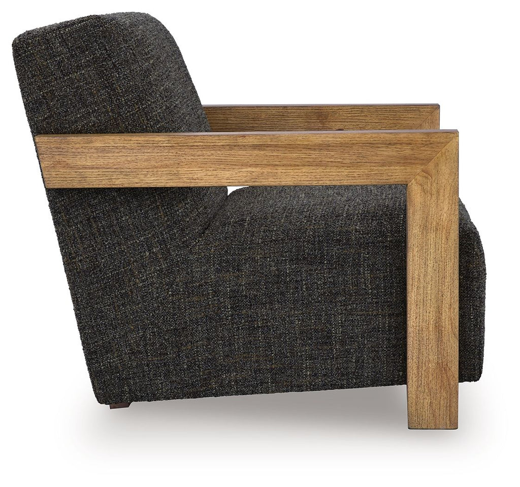 Charcoal fabric accent chair viewed from side with wooden arm frame and legs