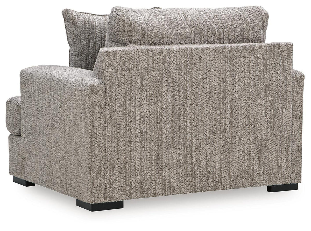 Gray chair and a half front view with textured fabric, padded arms, and low legs