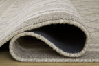 Gray rug corner with stitched edge and folded underside