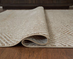 Beige rug with geometric weave and visible rolled edge, low pile texture