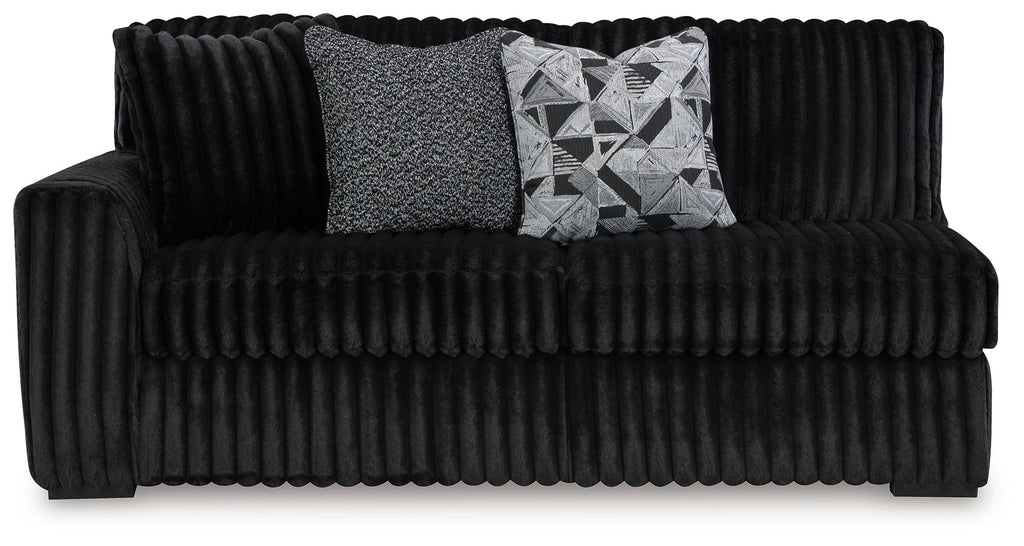 Tufted ribbed onyx black sofa with armrests, two accent pillows, and wide seat
