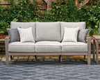 Gray outdoor sofa with two side throw pillows, striped and patterned cushion inserts