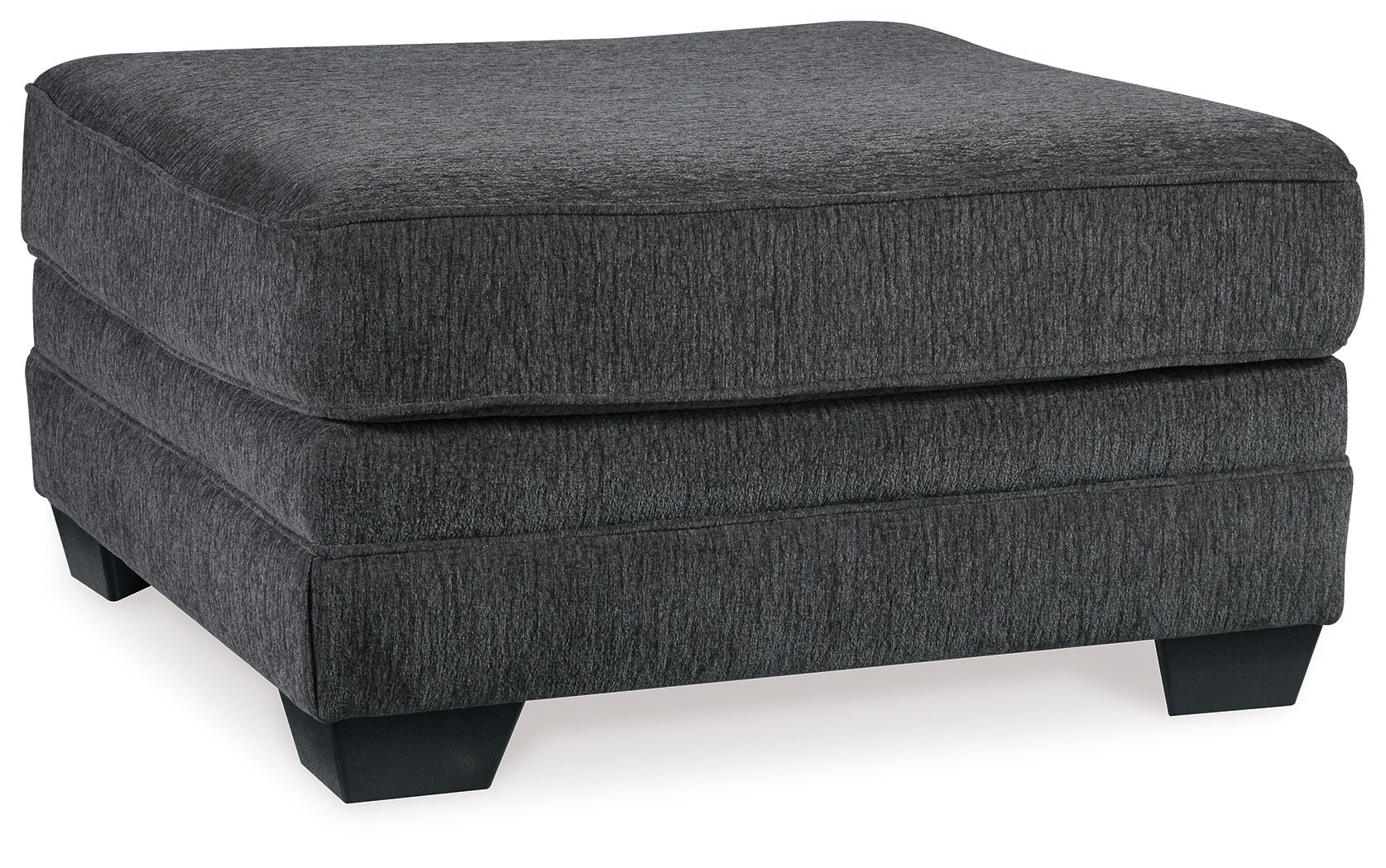 Slate gray upholstered ottoman with rounded top, padded sides, and dark legs