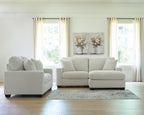 Light gray sofa and loveseat set with five throw pillows and dark block feet