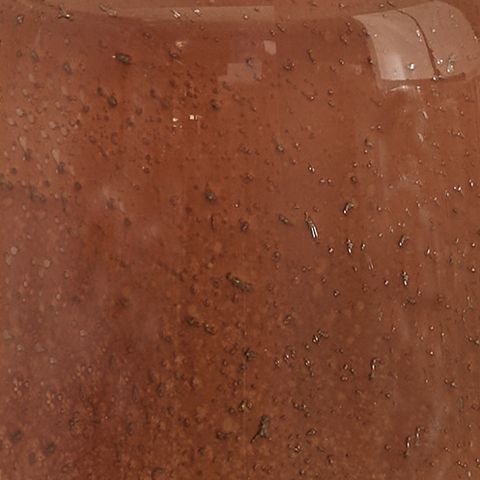 Rust-speckled glass lamp body close-up with reflective speckles