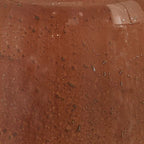 Rust-speckled glass lamp body close-up with reflective speckles