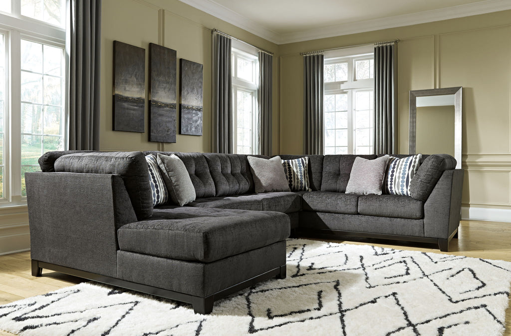 Gray sectional sofa with corner chaise and patterned accent pillows