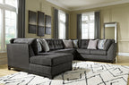Gray sectional sofa with corner chaise and patterned accent pillows