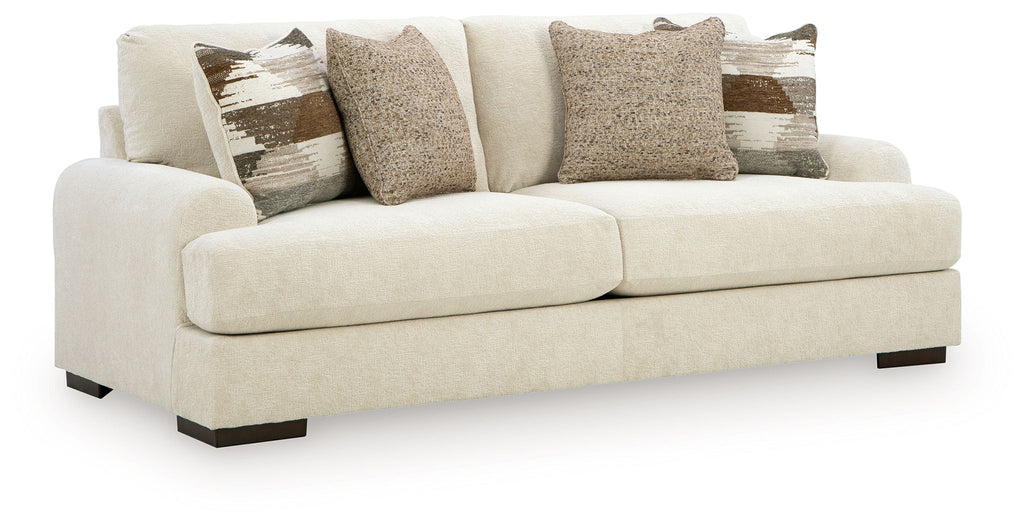Light beige fabric sofa with boxy arms and three seat cushions