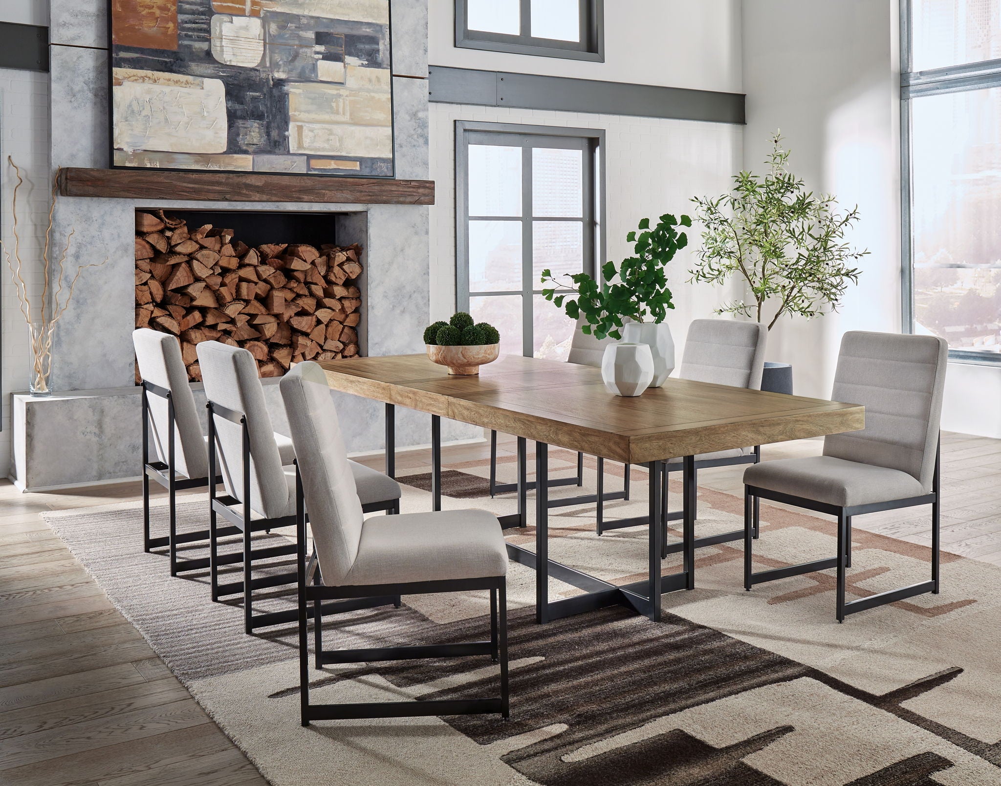 Dining set with light brown table and six gray upholstered chairs, black metal legs.