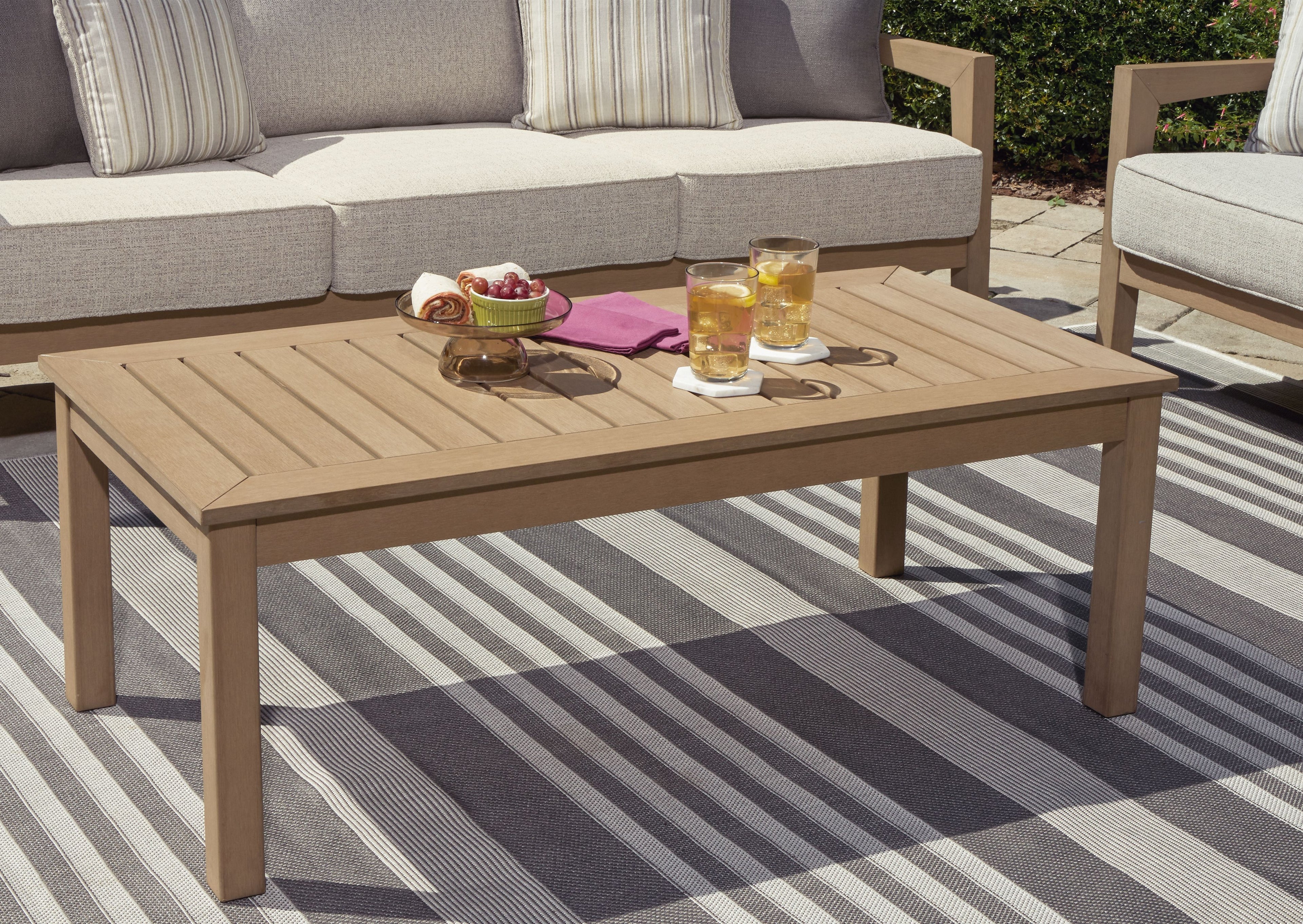Rectangular driftwood cocktail table with slatted tabletop and four straight legs.