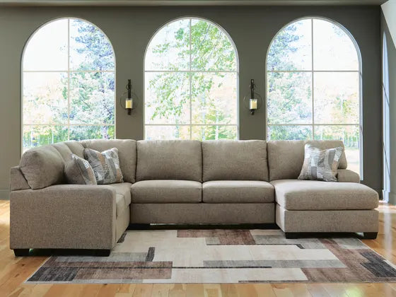 Taupe fabric sectional sofa with two chaise ends and matching throw pillows