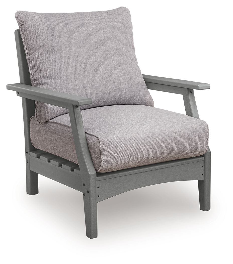 Gray lounge chair with slanted armrests, back cushion, and padded seat cushion