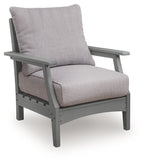 Gray lounge chair with slanted armrests, back cushion, and padded seat cushion