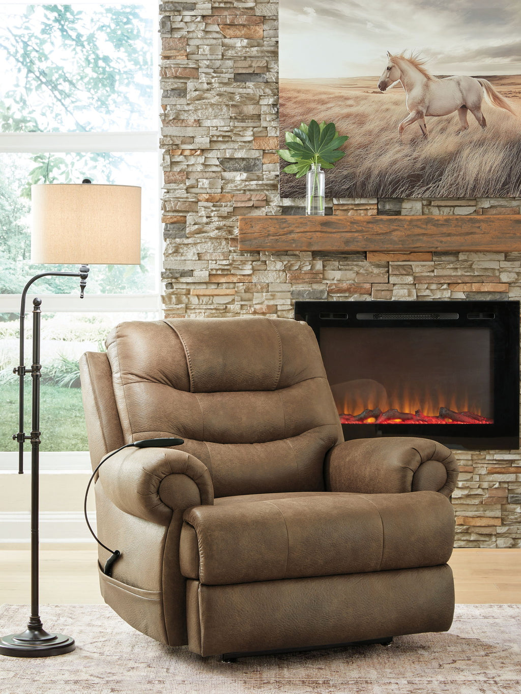 Tan leather-look power lift recliner in living room setting with curved padded arms