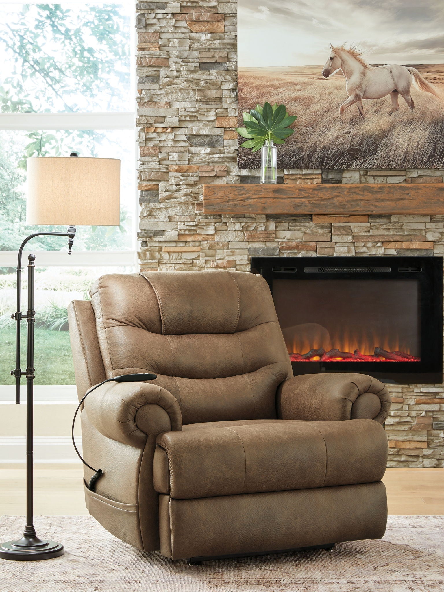 Tan leather-look power lift recliner in living room setting with curved padded arms