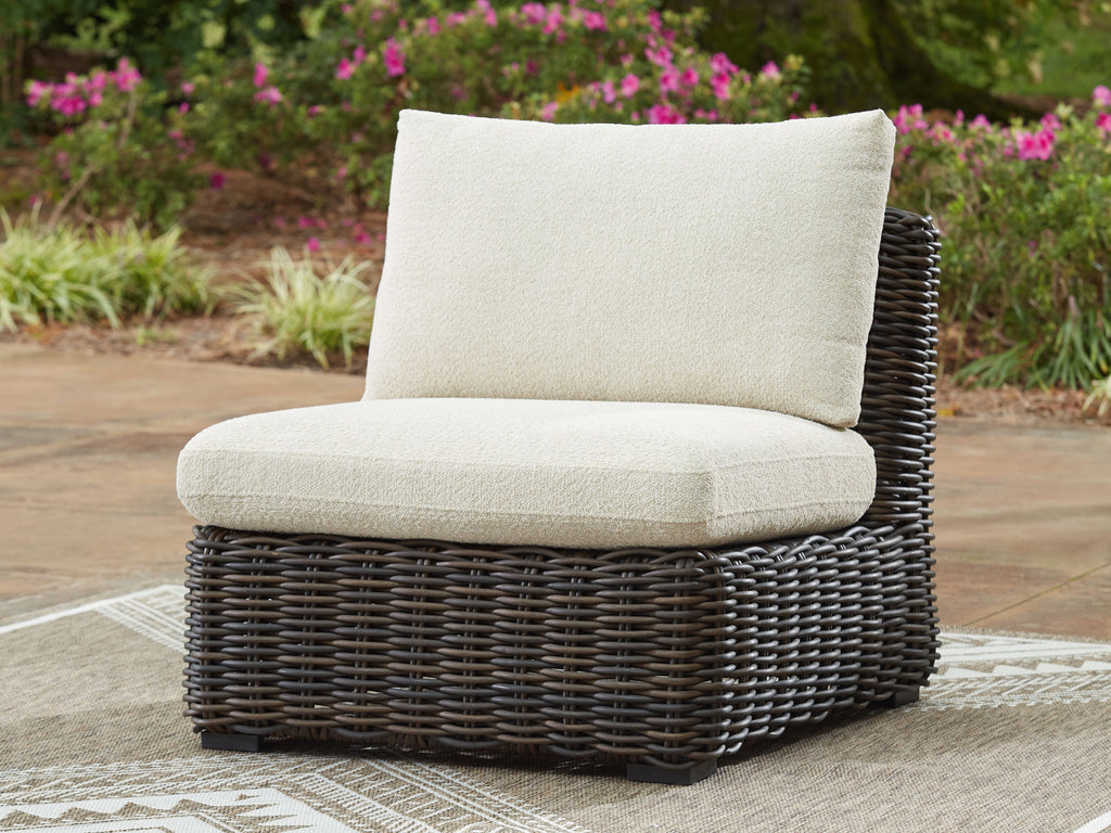 Armless wicker chair with beige cushions on dark brown woven body